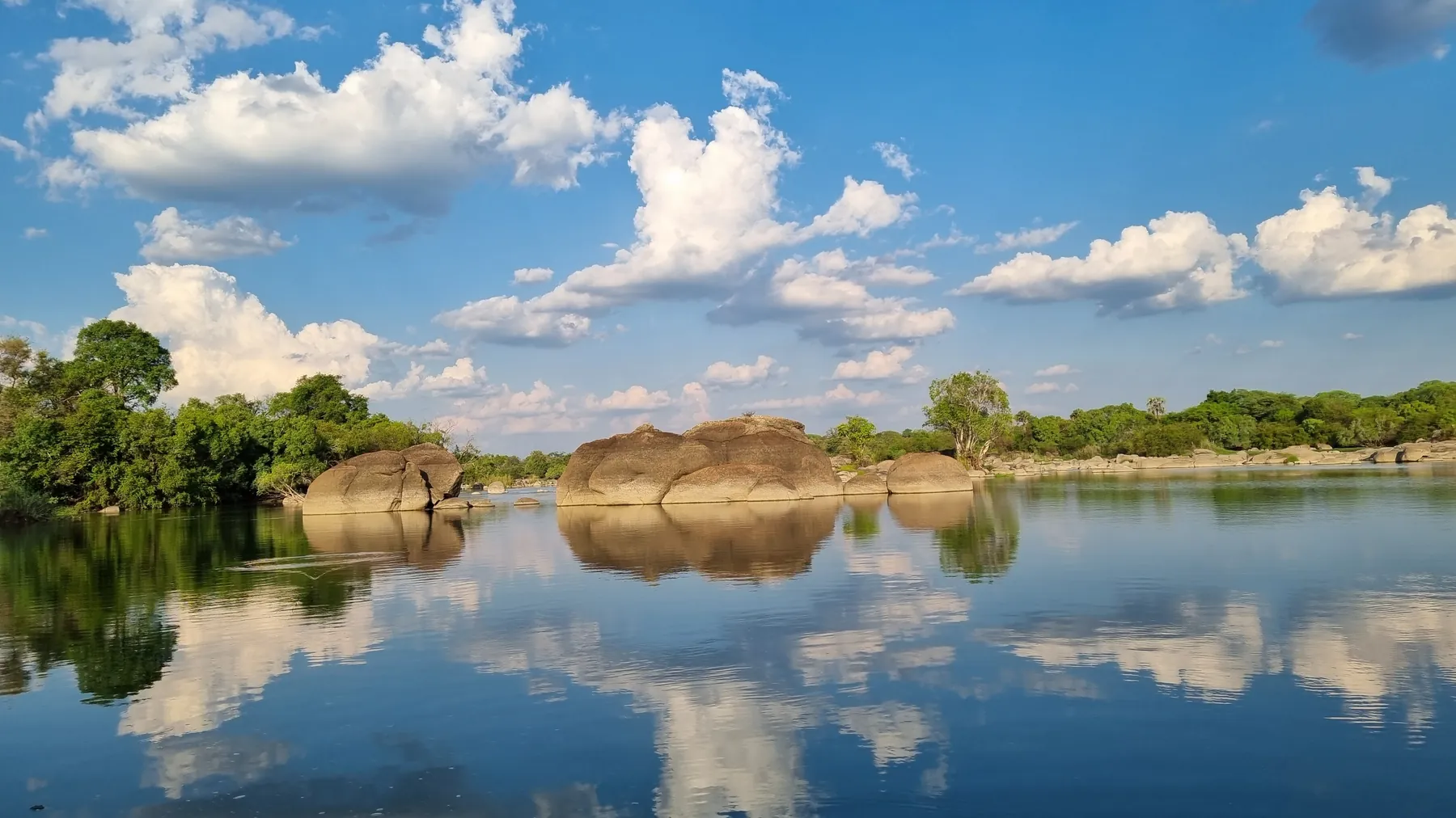 The Kafue River reflecting a clear blue sky, Zambia